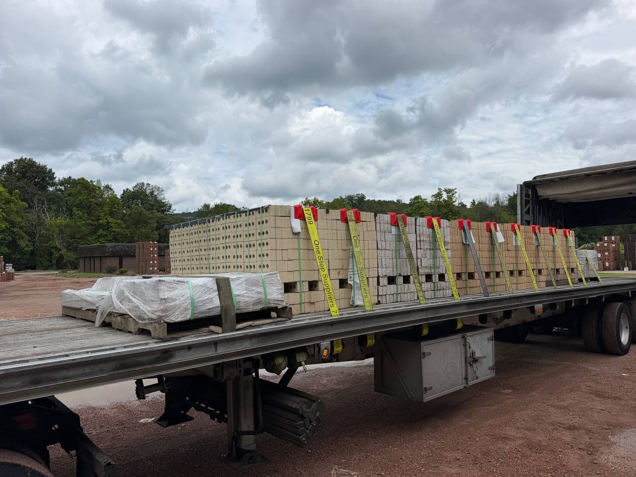 Pallets of bricks strapped on a flatbed deck